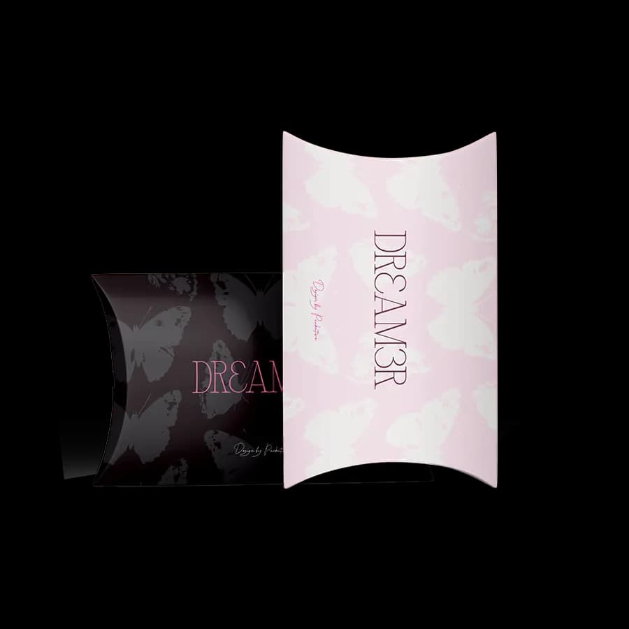 Two pillow-shaped boxes, one pink with "DREAM3R" text, and one black with butterfly designs, positioned side by side.
